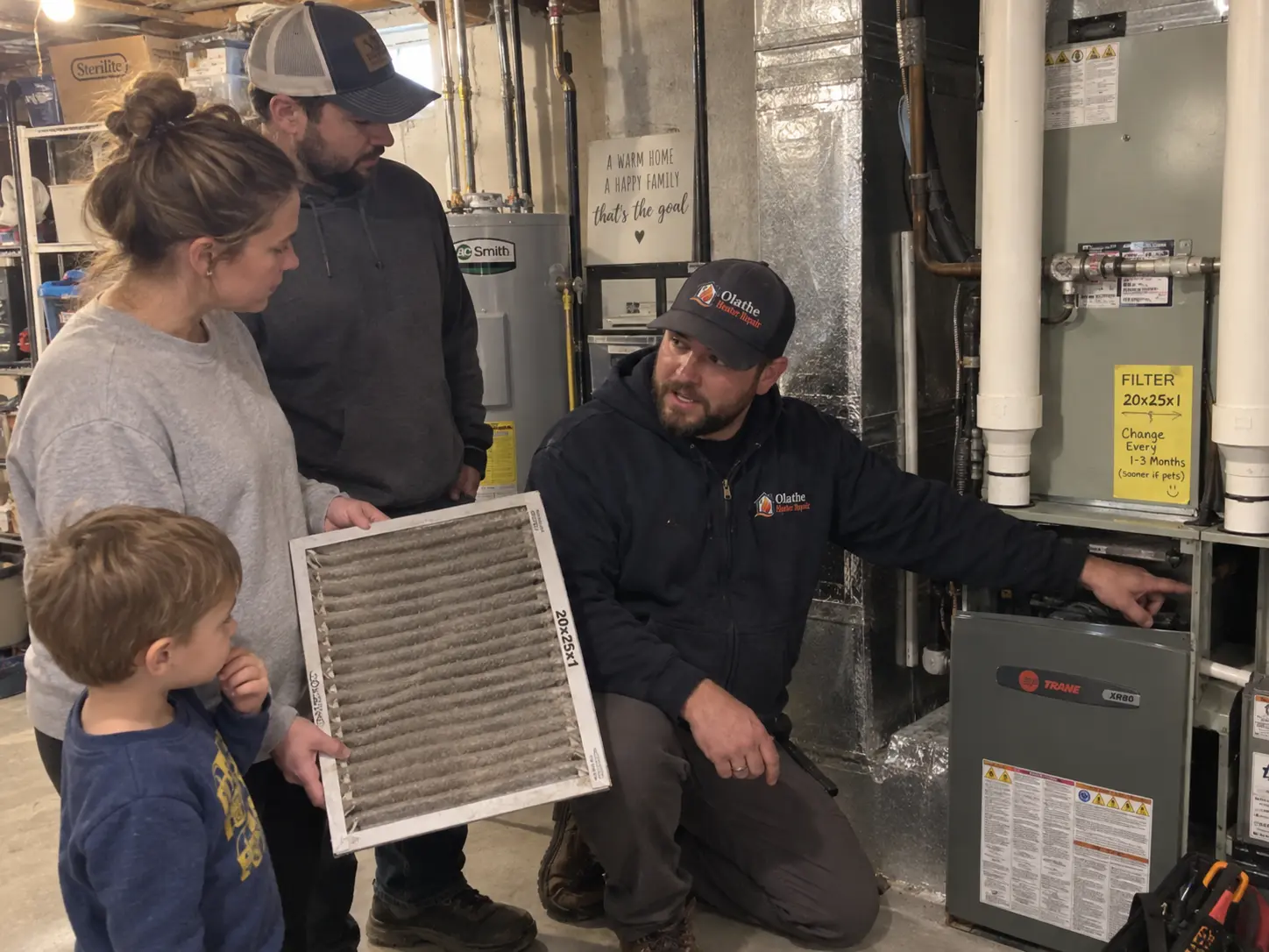 Technician showing a homeowner a dirty 20x25x1 furnace filter next to a Trane furnace