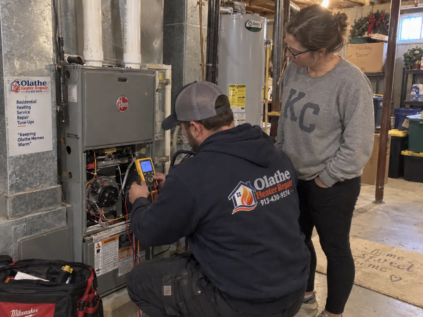 Technician taking a voltage reading with a multimeter inside a Rheem furnace control area